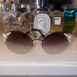 Miu Miu Sunglasses with gradient grey lens and pearl accents.